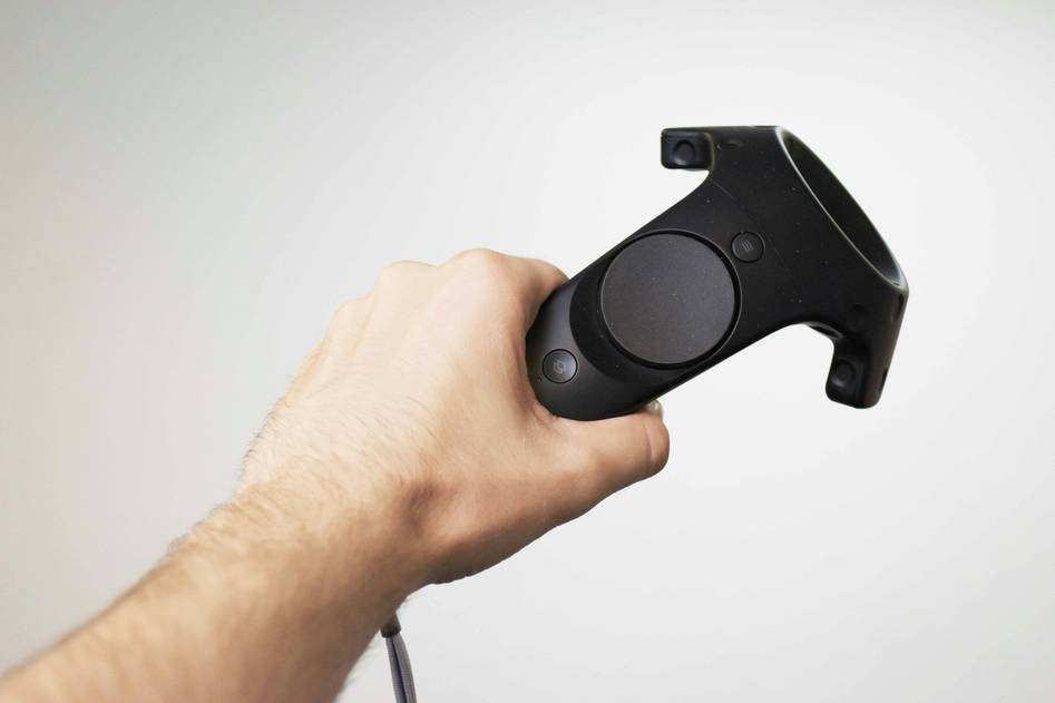 Close-up of hands holding modern motion controllers with LED tracking lights